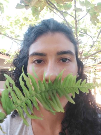 xRainbow Rafa Beleze with a fern cover her face.